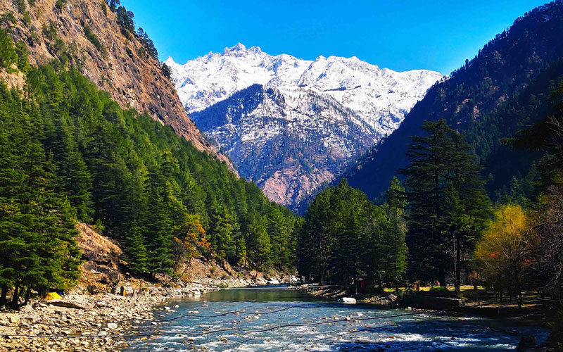 Scenic Kasol village surrounded by pine forests and mountains in Himachal Pradesh